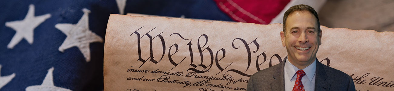 United States Constitution, rolled in a scroll on a vintage American flag and rustic wooden board